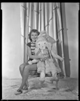 Barbara Read, actress, holding a large doll, circa 1934-1936