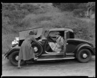 Fred Keating, actor, and a woman at a parked car in the Hollywood Hills, Los Angeles, circa 1934