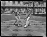 Johnny Mack Brown, actor, playing a game with a woman, Lake Arrowhead, circa 1929-1934