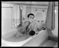 Fred Keating, actor, taking a bath at his home in the Holywood Hills "Casa Escrow," Los Angeles, circa 1934