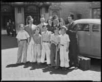 Children standing in front of adults who wear Shriners fezzes, including Lyle Talbot, actor, circa 1932-1939
