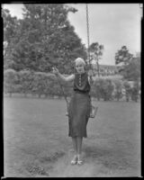 Woman sitting on a swing, circa 1932-1939