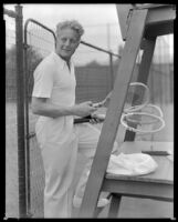 Gene Raymond, actor, holding tennis rackets, circa 1933