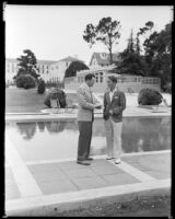 Lyle Talbot, actor, and another man standing by a swimming pool at the Hotel Del Monte, Monterey, circa 1932-1939