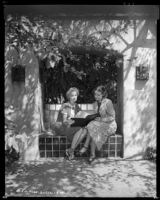 Woman and Louise Stanley, actress, looking at a notebook, Claremont, circa 1938