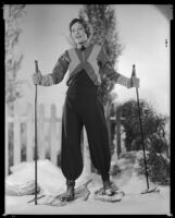 Woman wearing snowshoes and holding ski poles, circa 1929-1934