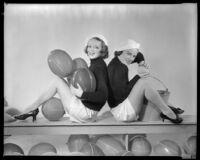 Inez Courtney, actress, holding balls and sitting back to back with a Sheila Mannors, actress, squeezing a sponge, circa 1934-1938