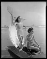 Geneva Mitchell and Mary Jo Mathews, actresses, on a boat on a beach, 1934