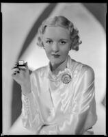 Virginia Pine, actress, holding a small clock, circa 1934-1935