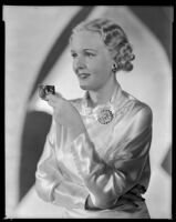 Virginia Pine, actress, holding a makeup compact, circa 1934-1935