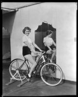 Billie Seward, actress, riding a stationary bicycle, circa 1934-1935