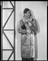 Virginia Pine, actress, modeling a fur coat, circa 1934-1935