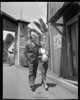 Victor Jory and Katherine De Mille, actors, walking through the Gold Gulch attraction at the California Pacific International Exposition, San Diego, 1935