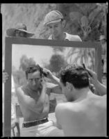 Victor Jory, actor, combing his hair, circa 1933-1939