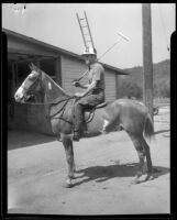 Man riding a horse and holding a polo mallet, circa 1935-1939