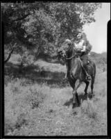 Marian Marsh, actress, riding a horse, circa 1935-1939