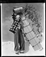 Marian Marsh, actress, holding a sled, circa 1935-1939