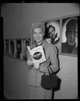 Actress with the book, Hollywood U.S.A. from script to screen, by Alice Evans Field, circa 1952