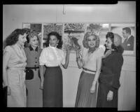 Charlita, actress, and four women standing next to photo stills from The Brave Bulls, circa 1951