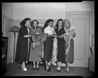 Charlita, actress, and four women admiring shawls, circa 1951