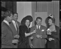 Robert Rossen, director, flanked by actresses Fanny Schiller and Katherine De Mille at a party for The Brave Bulls, circa 1950-1951