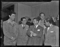 Robert Rossen, director, with actor Mel Ferrer and attendees of a party for The Brave Bulls, circa 1950-1951