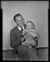 Lee Bowman, actor, seated on floor with son Lucien, circa 1943-1944