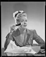 Janis Carter, actress, with a facial brush, 1946