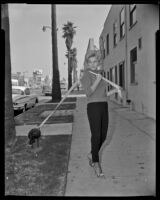 Elizabeth MacRae, actress, walking a turkey in a publicity still for Everything’s Ducky, circa 1961