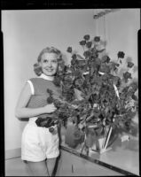 Norma Randall, actress, with roses, circa 1953