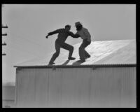 Two men fighting on a roof in an unidentified film, 1940s or 1950s