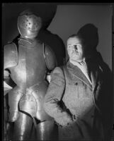 Jack Holt, actor, beside a suit of armor, 1927-1939