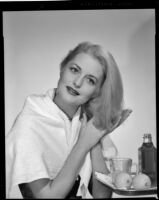 Constance Towers, actress, applying a hair treatment, circa 1955