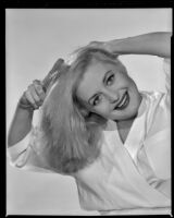 Constance Towers, actress, brushing her hair, circa 1955