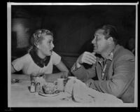 Constance Towers, singer and actress, conversing with actor and comedian Jack Carson, copy print, [rephotographed] circa 1955