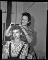 Woman combing another woman's hair, 1940s