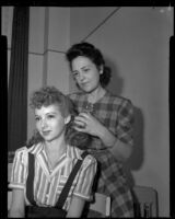 Woman arranging another woman's hair, 1940s