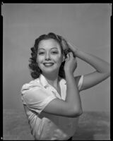 Woman brushing her hair, 1940s