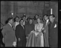 Robert Rossen, director, with actors Joan Crawford and Mel Ferrer amongst others, during filming of Harriet Craig and The Brave Bulls, 1950