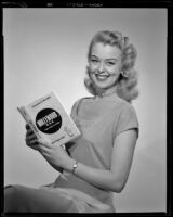 Actress with the book, Hollywood U.S.A. from script to screen, by Alice Evans Field, circa 1952