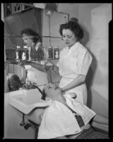 Gloria Henry, actress, having her hair washed by a beautician, circa 1947-1951