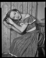 Gloria Henry, actress, brushing her hair, circa 1947-1951