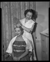 Gloria Henry, actress, receiving a hair treatment from a beautician, circa 1947-1951