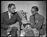 Robert Kalloch, costume designer, assessing fabric samples with a second man, circa 1939-1940