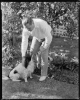 Jack Holt, actor, in his yard with a dog, Santa Monica, 1934