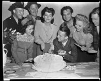 Rosalind Russell celebrating her birthday with Shirley Temple, director Alexander Hall, and fellow cast members of My Sister Eileen, copy print, 1942