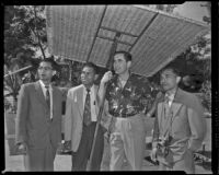 Tyrone Power, actor, and three men, on the grounds of his Bel Air home, circa 1955