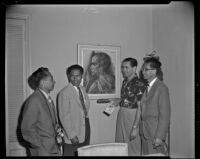Tyrone Power, actor, and three men in his Bel Air home tanding next to a painting by Rudolf Bonnet, circa 1955