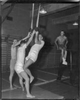 William Leslie, Patrick Wayne, Philip Carey and Robert Francis in a gym during production of The Long Gray Line, 1954