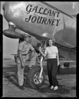 Man and woman standing beneath a plane with the title, "Gallant Journey" painted on it, 1946